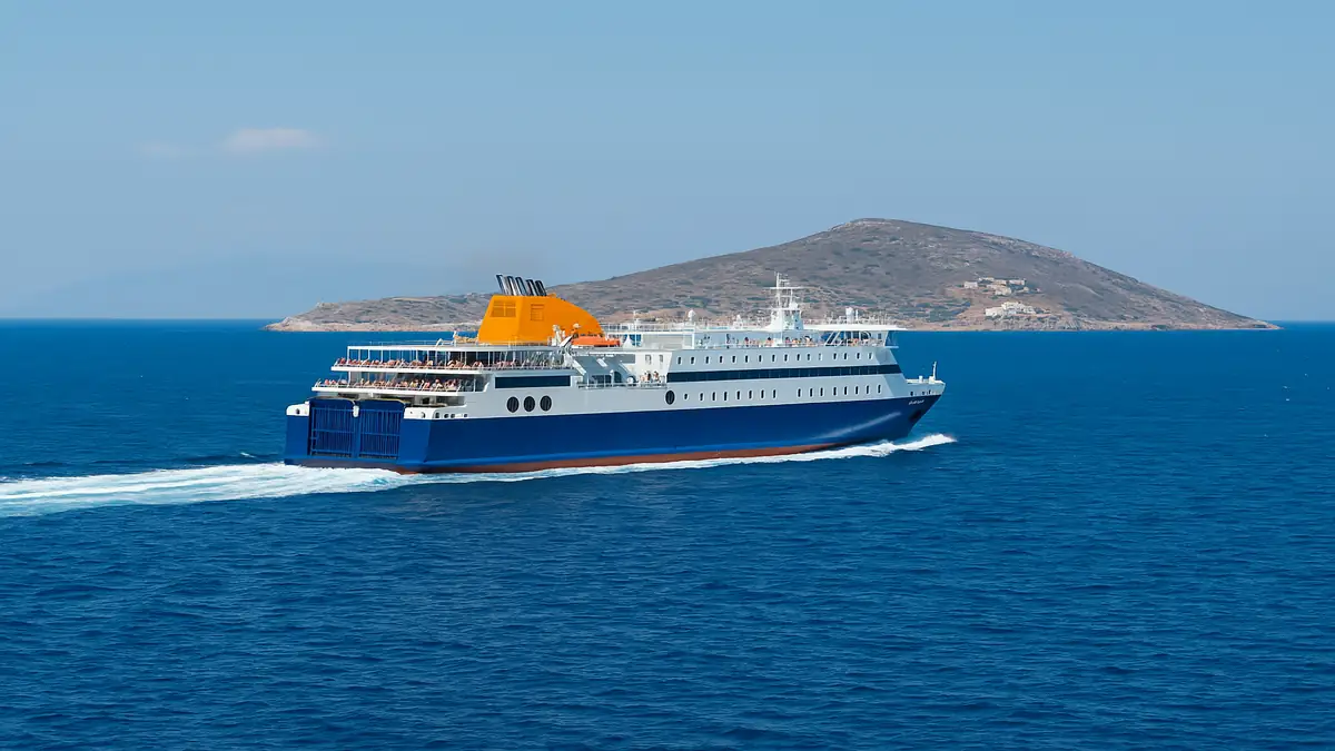 Greece Travel Guide 2025: Essential Tips for an Unforgettable First Trip 7 Modern ferry boat sailing on the Aegean Sea with island in the background – Greece Travel Guide