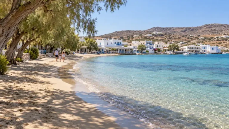 Where to Stay in Milos for Families: Best Base by Kids' Age 6 Tamarisk shade along a sandy village bay, with a family walking beside clear shallow water in a representation of Pollonia, Milos.