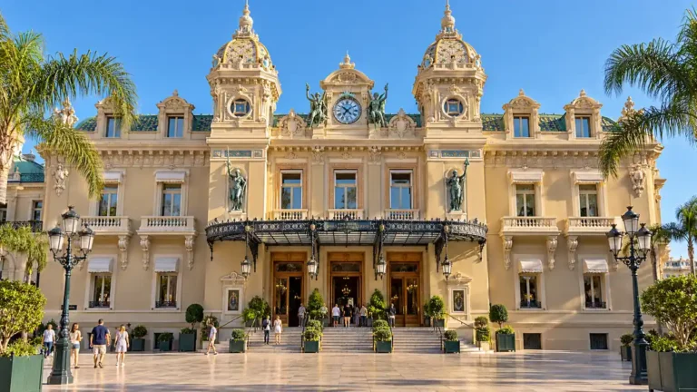 Monte Carlo Travel Guide: Beyond the Casino, on Any Budget 5 Ornate cream facade and twin towers of the Casino de Monte-Carlo framed by palms.