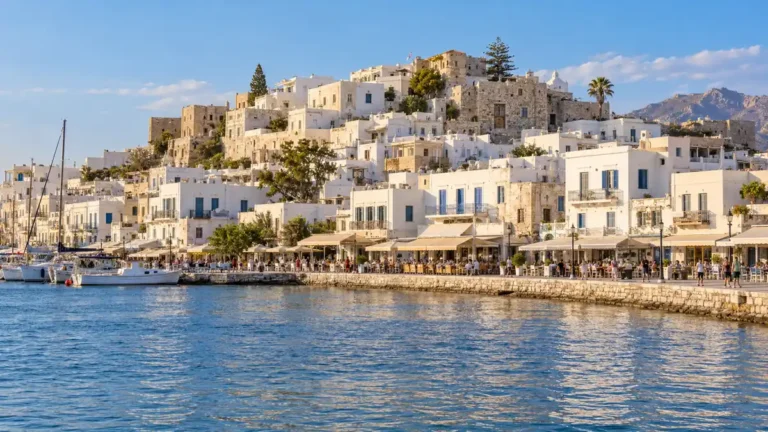 Whitewashed Naxos Town rises above its waterfront promenade and blue harbour