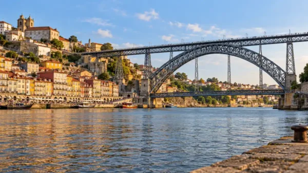 Dom Luis I Bridge spans the Douro beside Porto's hillside waterfront, viewed from the Gaia quay.
