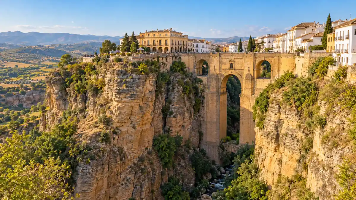 Travel to Spain: Best Cities, 7–14 Day Itineraries and Planning Tips 2 Puente Nuevo spans Ronda's rocky gorge beneath whitewashed buildings in warm afternoon light.