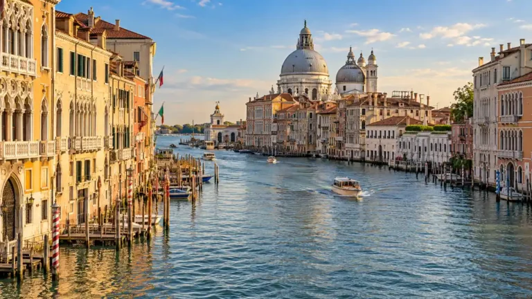 Warm sunlight on Venetian palaces beside the Grand Canal with Santa Maria della Salute in the distance